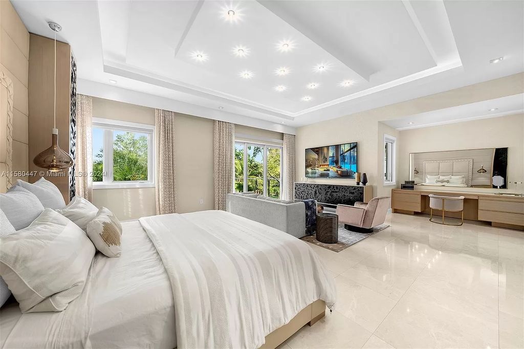 Enter a world of luxury in this exquisite 2-story gated sanctuary. Boasting a grand foyer, chef's kitchen, 4-suite bedrooms, elevator, home theater, and tropical backyard oasis with a guest house, this home offers unparalleled living.