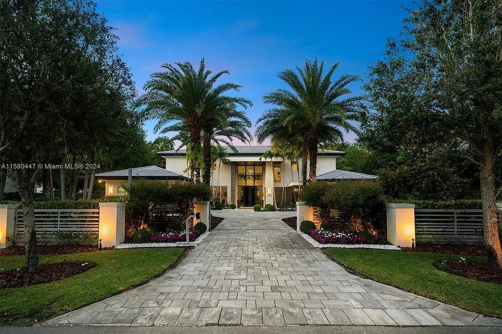 Enter a world of luxury in this exquisite 2-story gated sanctuary. Boasting a grand foyer, chef's kitchen, 4-suite bedrooms, elevator, home theater, and tropical backyard oasis with a guest house, this home offers unparalleled living.