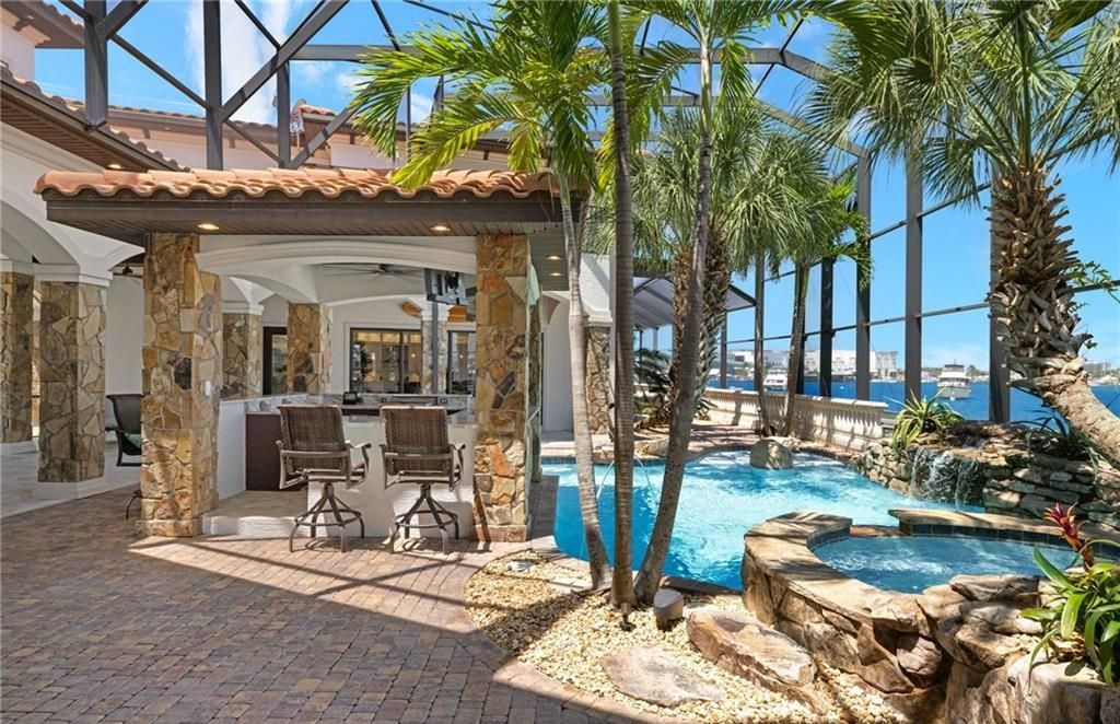 Boasting 180 feet of waterfront, a private dock, and an expansive pool area, this 4-bedroom haven offers endless opportunities for relaxation and adventure.