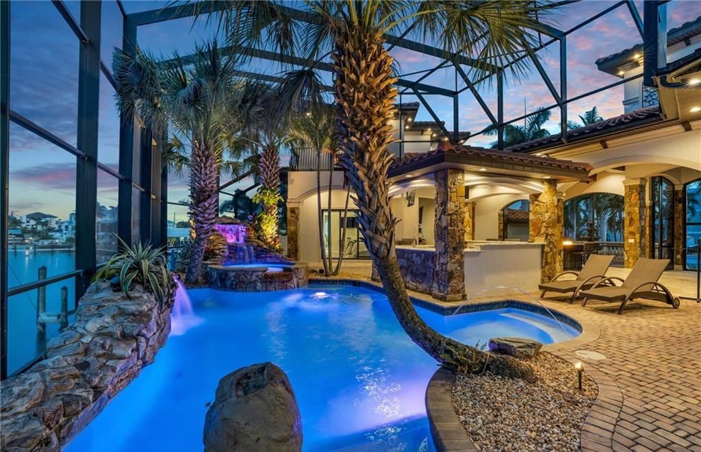 Boasting 180 feet of waterfront, a private dock, and an expansive pool area, this 4-bedroom haven offers endless opportunities for relaxation and adventure.