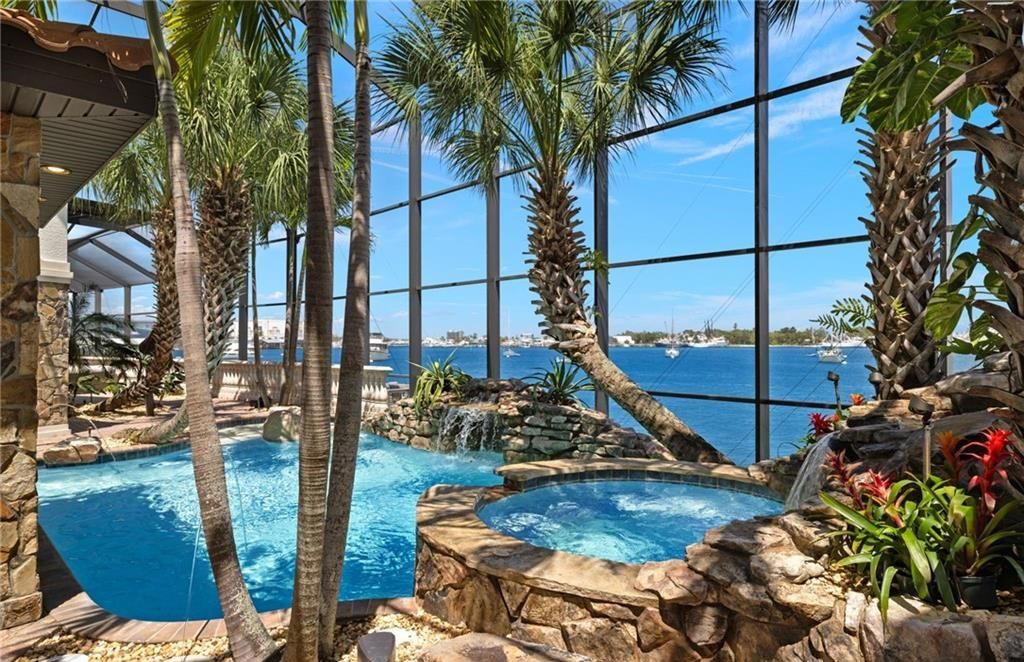 Boasting 180 feet of waterfront, a private dock, and an expansive pool area, this 4-bedroom haven offers endless opportunities for relaxation and adventure.