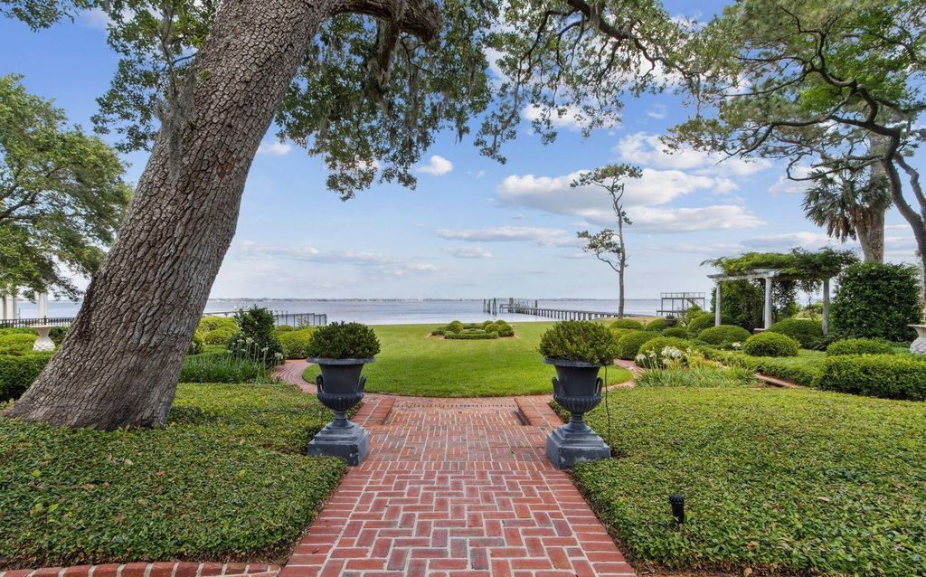 This 5-bedroom estate boasts breathtaking riverfront views, expansive grounds, and a floor plan designed for entertaining. Hardwood floors, fireplaces, and a gourmet kitchen create an unforgettable ambiance.