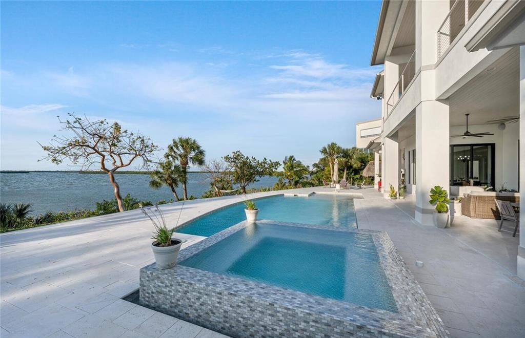 Unwind in paradise at this exquisite 12,000+ square feet estate on a private island in Marco Island. This boater's dream home boasts breathtaking water views, a gourmet kitchen, a wine cellar, a pool, and access to exclusive community amenities. Don't miss this rare opportunity!