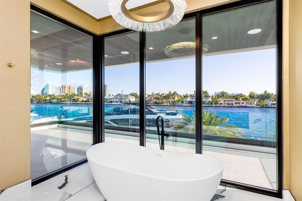 Unmatched Intracoastal views meet unparalleled luxury in this waterfront estate by the esteemed Crest Group and Bruce Celenski. Boasting a spa, media room, gourmet kitchens, smart home features, private dock, pool and rooftop deck, this residence redefines beachfront living.