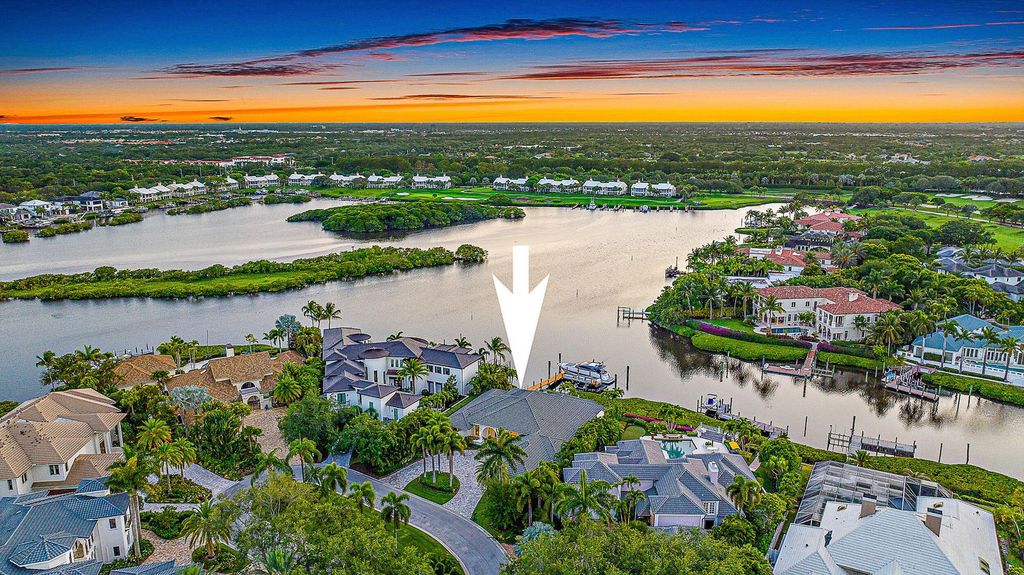 Immerse yourself in luxury living at this custom waterfront estate. Breathtaking water views, sunsets, and a private dock make this your dream home. Updated kitchen, spacious suites, and prime location near the Club. Schedule a showing today!