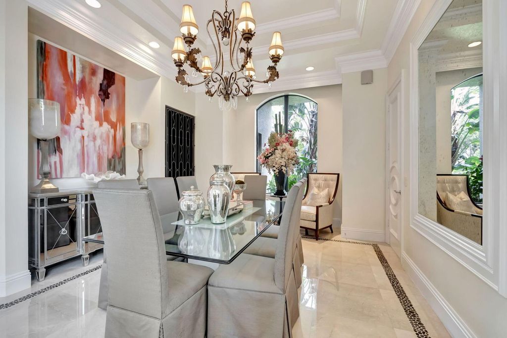 Discover unparalleled luxury in this meticulously crafted Boca Raton estate. This showcase former model home boasts a saltwater pool, spa, state-of-the-art movie theatre, wine cellar, and resort-style amenities. Experience ultimate privacy in a prestigious gated community next to a nature preserve.