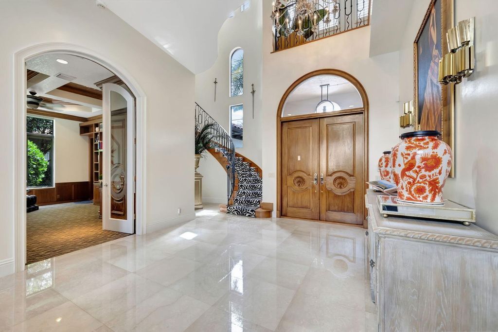 Discover unparalleled luxury in this meticulously crafted Boca Raton estate. This showcase former model home boasts a saltwater pool, spa, state-of-the-art movie theatre, wine cellar, and resort-style amenities. Experience ultimate privacy in a prestigious gated community next to a nature preserve.