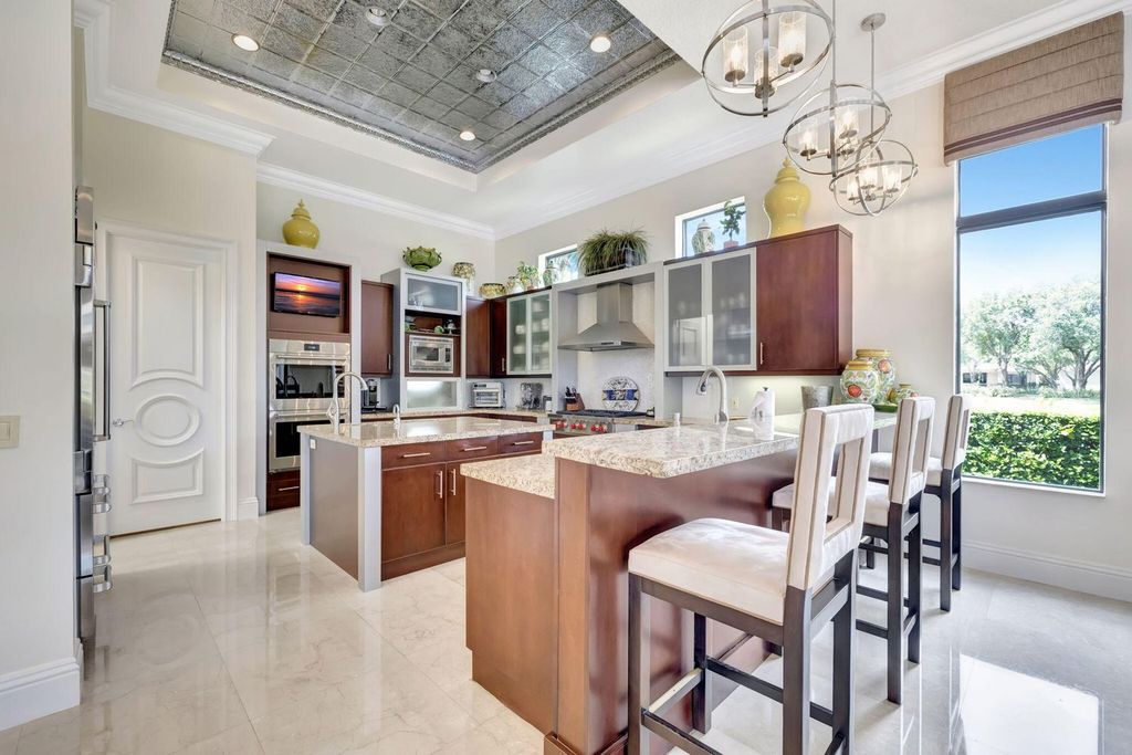 Discover unparalleled luxury in this meticulously crafted Boca Raton estate. This showcase former model home boasts a saltwater pool, spa, state-of-the-art movie theatre, wine cellar, and resort-style amenities. Experience ultimate privacy in a prestigious gated community next to a nature preserve.