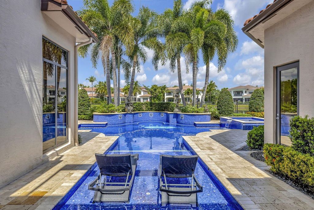 Discover unparalleled luxury in this meticulously crafted Boca Raton estate. This showcase former model home boasts a saltwater pool, spa, state-of-the-art movie theatre, wine cellar, and resort-style amenities. Experience ultimate privacy in a prestigious gated community next to a nature preserve.