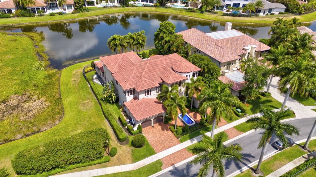 Discover unparalleled luxury in this meticulously crafted Boca Raton estate. This showcase former model home boasts a saltwater pool, spa, state-of-the-art movie theatre, wine cellar, and resort-style amenities. Experience ultimate privacy in a prestigious gated community next to a nature preserve.