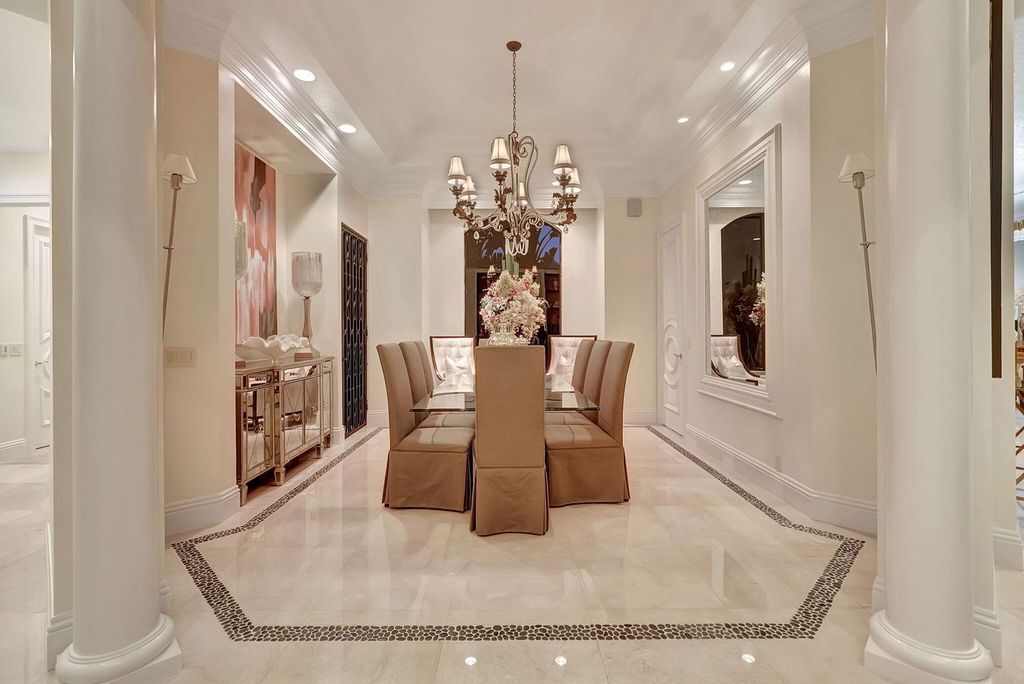 Discover unparalleled luxury in this meticulously crafted Boca Raton estate. This showcase former model home boasts a saltwater pool, spa, state-of-the-art movie theatre, wine cellar, and resort-style amenities. Experience ultimate privacy in a prestigious gated community next to a nature preserve.