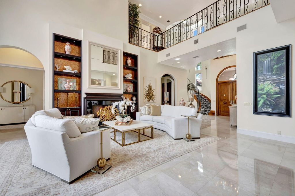 Discover unparalleled luxury in this meticulously crafted Boca Raton estate. This showcase former model home boasts a saltwater pool, spa, state-of-the-art movie theatre, wine cellar, and resort-style amenities. Experience ultimate privacy in a prestigious gated community next to a nature preserve.