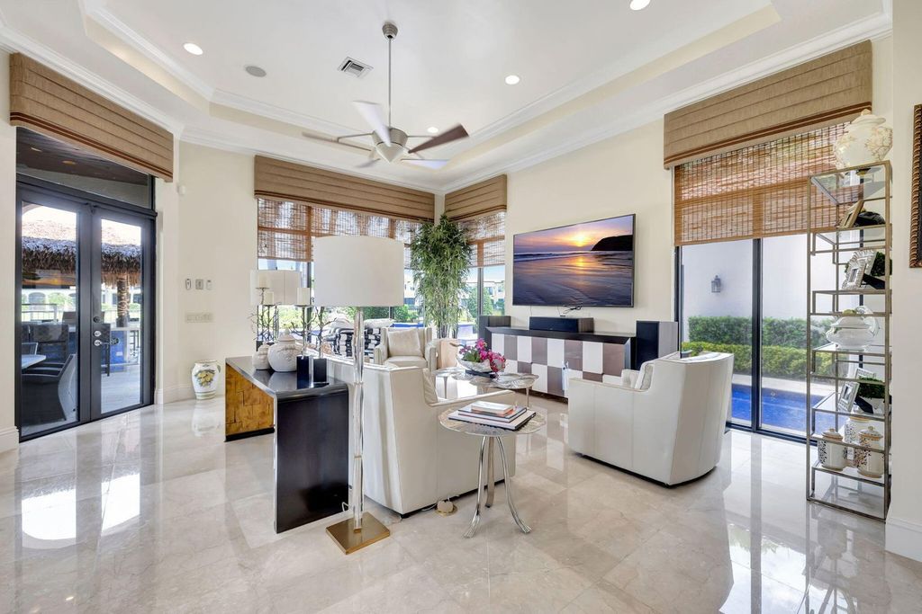 Discover unparalleled luxury in this meticulously crafted Boca Raton estate. This showcase former model home boasts a saltwater pool, spa, state-of-the-art movie theatre, wine cellar, and resort-style amenities. Experience ultimate privacy in a prestigious gated community next to a nature preserve.