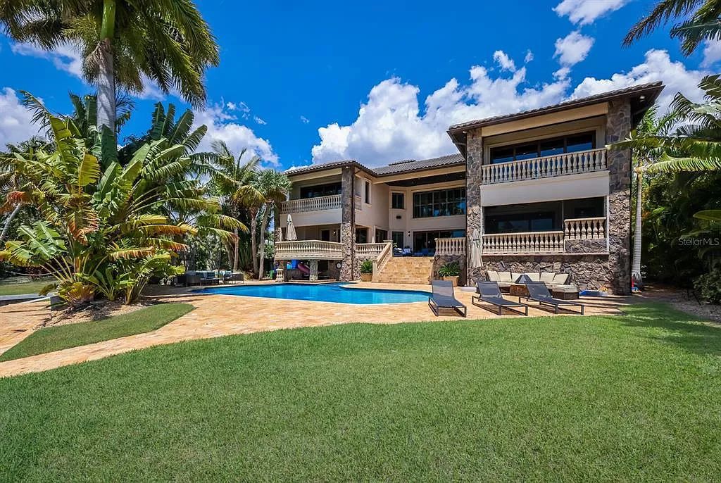 This 7,960 square feet waterfront mansion in San Remo Estates offers unparalleled luxury living. Imagine sprawling bay views, a sparkling pool with swim-up bar, gourmet kitchen, and multiple terraces for entertaining.