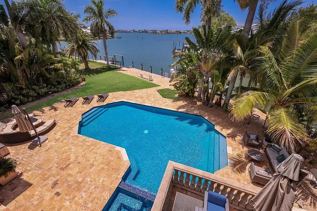 This 7,960 square feet waterfront mansion in San Remo Estates offers unparalleled luxury living. Imagine sprawling bay views, a sparkling pool with swim-up bar, gourmet kitchen, and multiple terraces for entertaining.