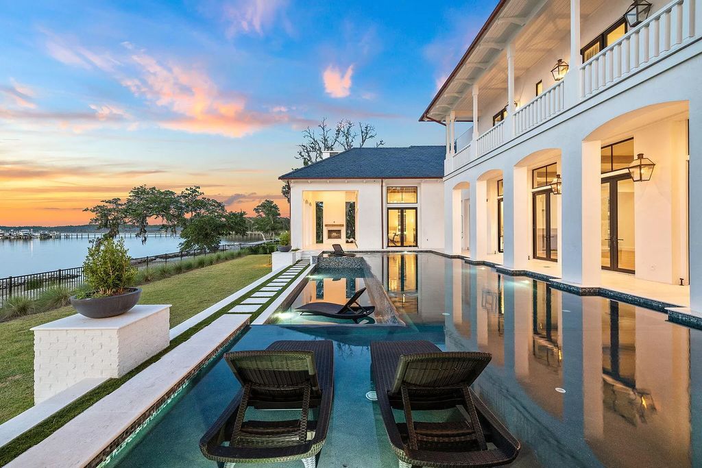 This extraordinary 7,587 square feet residence boasts 6 spacious bedrooms, 7 custom bathrooms, an infinity pool with swim-up bar, a coveted 70' private boat slip, and breathtaking bay views.