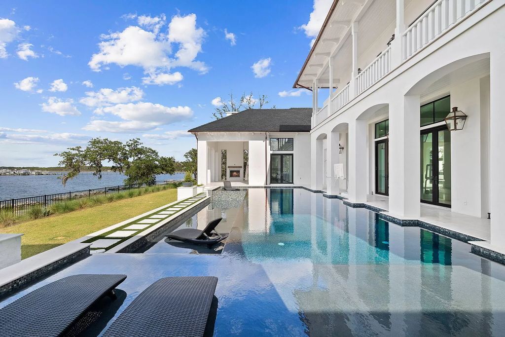 This extraordinary 7,587 square feet residence boasts 6 spacious bedrooms, 7 custom bathrooms, an infinity pool with swim-up bar, a coveted 70' private boat slip, and breathtaking bay views.