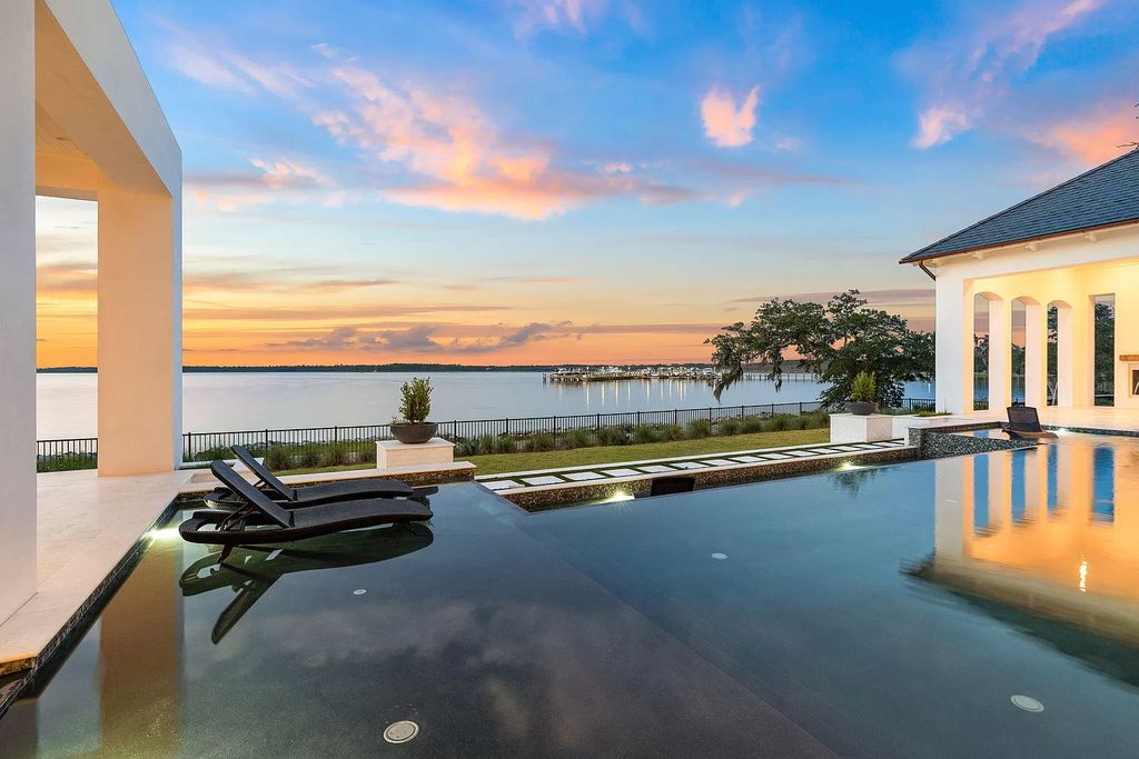 This extraordinary 7,587 square feet residence boasts 6 spacious bedrooms, 7 custom bathrooms, an infinity pool with swim-up bar, a coveted 70' private boat slip, and breathtaking bay views.