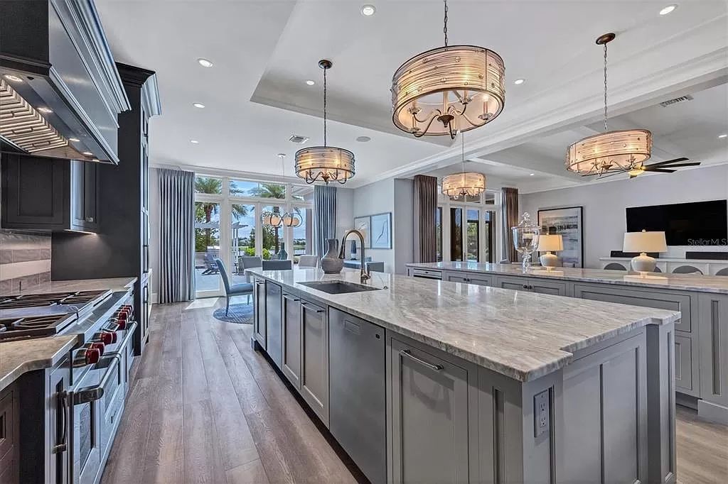 Experience the epitome of luxurious living in this 5-bed estate designed by renowned builders and designers. Featuring a gourmet kitchen, spa-like master suite, saltwater pool and casita, this home redefines Florida living.