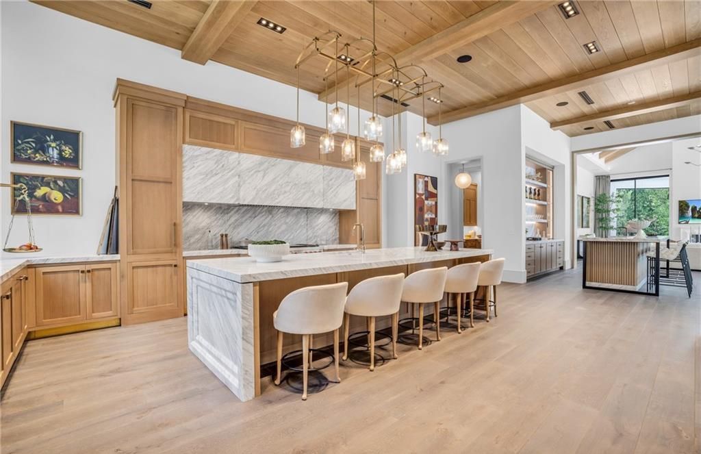 Built by Borelli Construction and designed by Carrie Brigham Design, this modern Tudor masterpiece boasts a chef's kitchen, expansive game room with wet bar, sparkling pool with pool house, private guest casita, resort-style lanai with fireplace, and top-of-the-line finishes throughout.