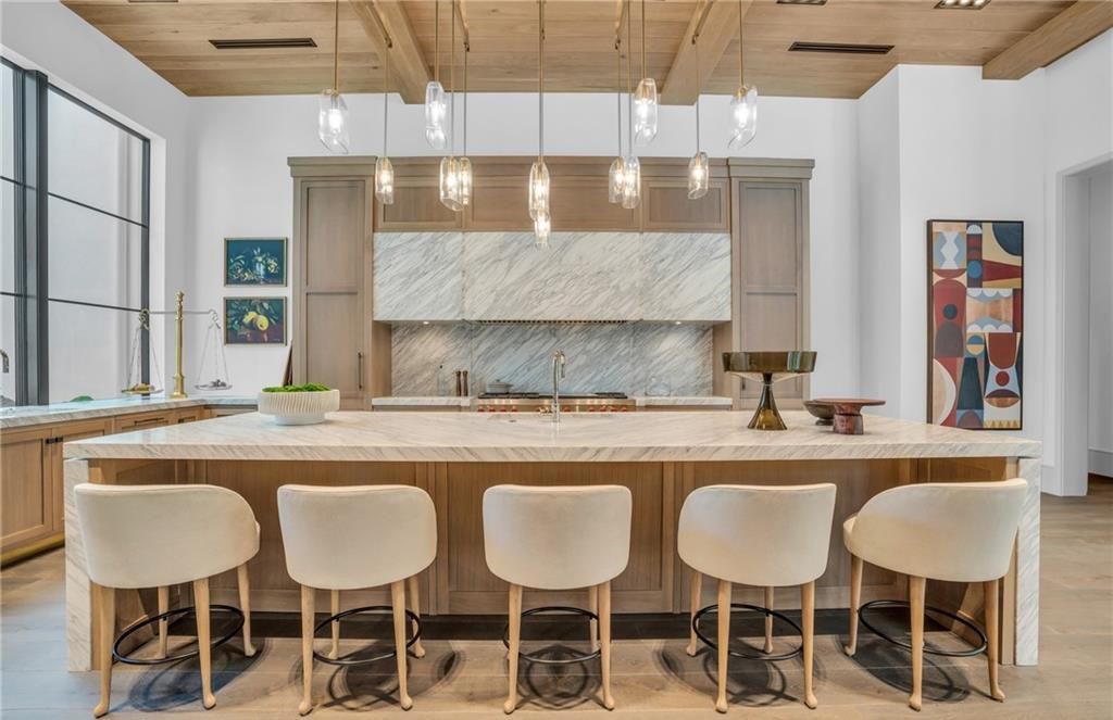 Built by Borelli Construction and designed by Carrie Brigham Design, this modern Tudor masterpiece boasts a chef's kitchen, expansive game room with wet bar, sparkling pool with pool house, private guest casita, resort-style lanai with fireplace, and top-of-the-line finishes throughout.