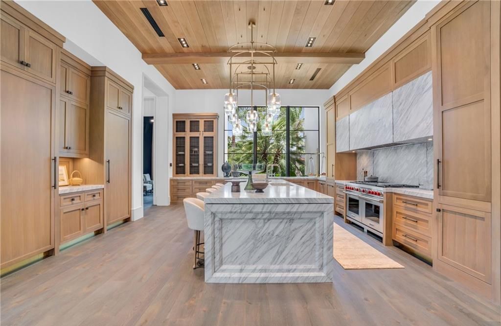 Built by Borelli Construction and designed by Carrie Brigham Design, this modern Tudor masterpiece boasts a chef's kitchen, expansive game room with wet bar, sparkling pool with pool house, private guest casita, resort-style lanai with fireplace, and top-of-the-line finishes throughout.