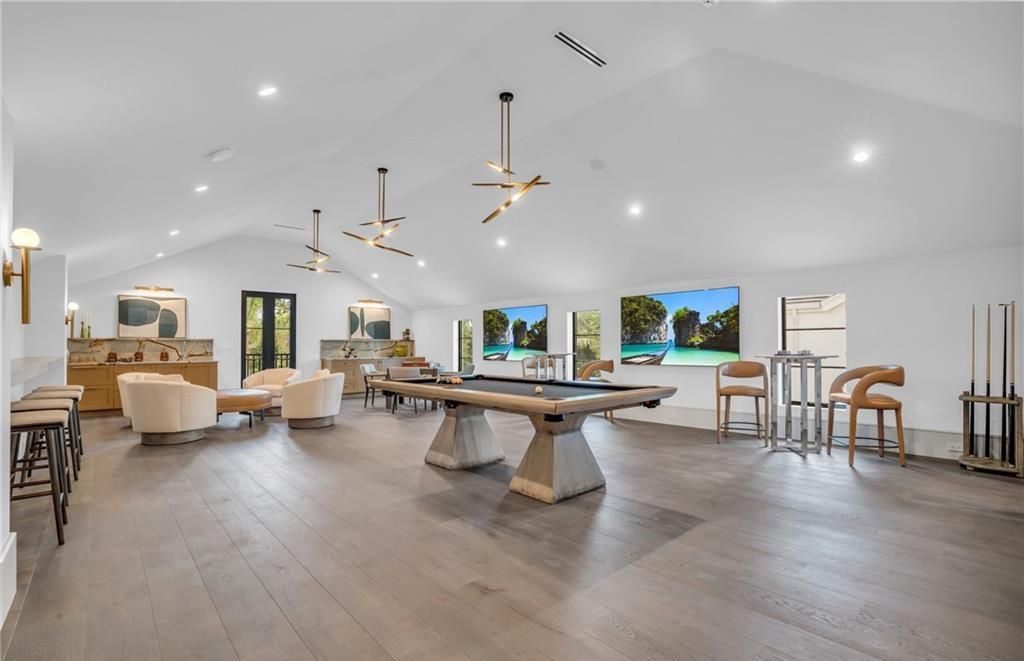 Built by Borelli Construction and designed by Carrie Brigham Design, this modern Tudor masterpiece boasts a chef's kitchen, expansive game room with wet bar, sparkling pool with pool house, private guest casita, resort-style lanai with fireplace, and top-of-the-line finishes throughout.