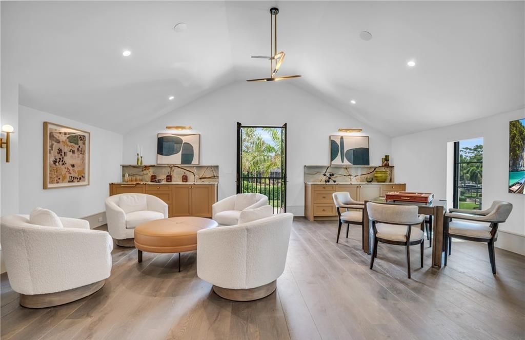 Built by Borelli Construction and designed by Carrie Brigham Design, this modern Tudor masterpiece boasts a chef's kitchen, expansive game room with wet bar, sparkling pool with pool house, private guest casita, resort-style lanai with fireplace, and top-of-the-line finishes throughout.