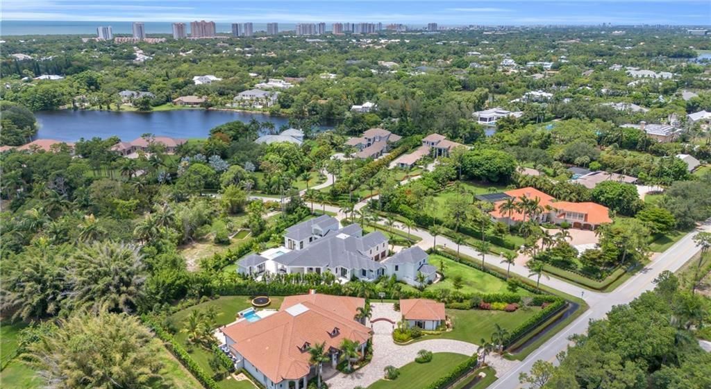 Built by Borelli Construction and designed by Carrie Brigham Design, this modern Tudor masterpiece boasts a chef's kitchen, expansive game room with wet bar, sparkling pool with pool house, private guest casita, resort-style lanai with fireplace, and top-of-the-line finishes throughout.