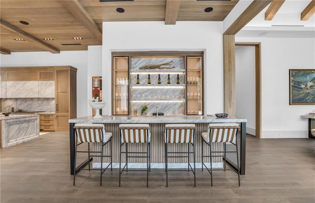 Built by Borelli Construction and designed by Carrie Brigham Design, this modern Tudor masterpiece boasts a chef's kitchen, expansive game room with wet bar, sparkling pool with pool house, private guest casita, resort-style lanai with fireplace, and top-of-the-line finishes throughout.