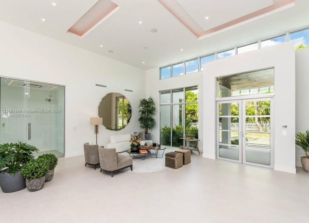 Featuring an infinity pool, a modern kitchen with top-of-the-line appliances, a stunning master suite, and close proximity to Gulliver Preparatory School, this expansive property offers the perfect blend of indoor and outdoor living.