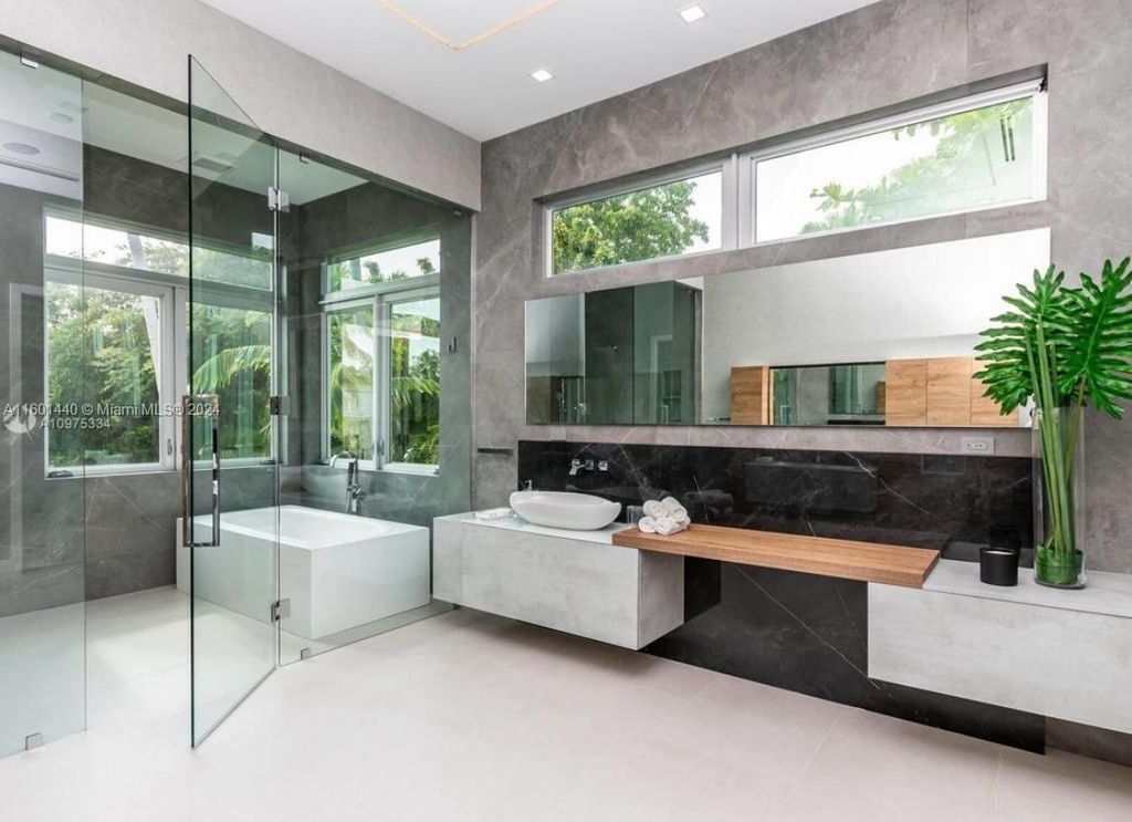 Featuring an infinity pool, a modern kitchen with top-of-the-line appliances, a stunning master suite, and close proximity to Gulliver Preparatory School, this expansive property offers the perfect blend of indoor and outdoor living.