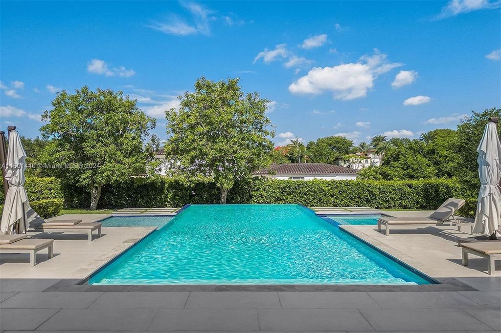 Featuring an infinity pool, a modern kitchen with top-of-the-line appliances, a stunning master suite, and close proximity to Gulliver Preparatory School, this expansive property offers the perfect blend of indoor and outdoor living.