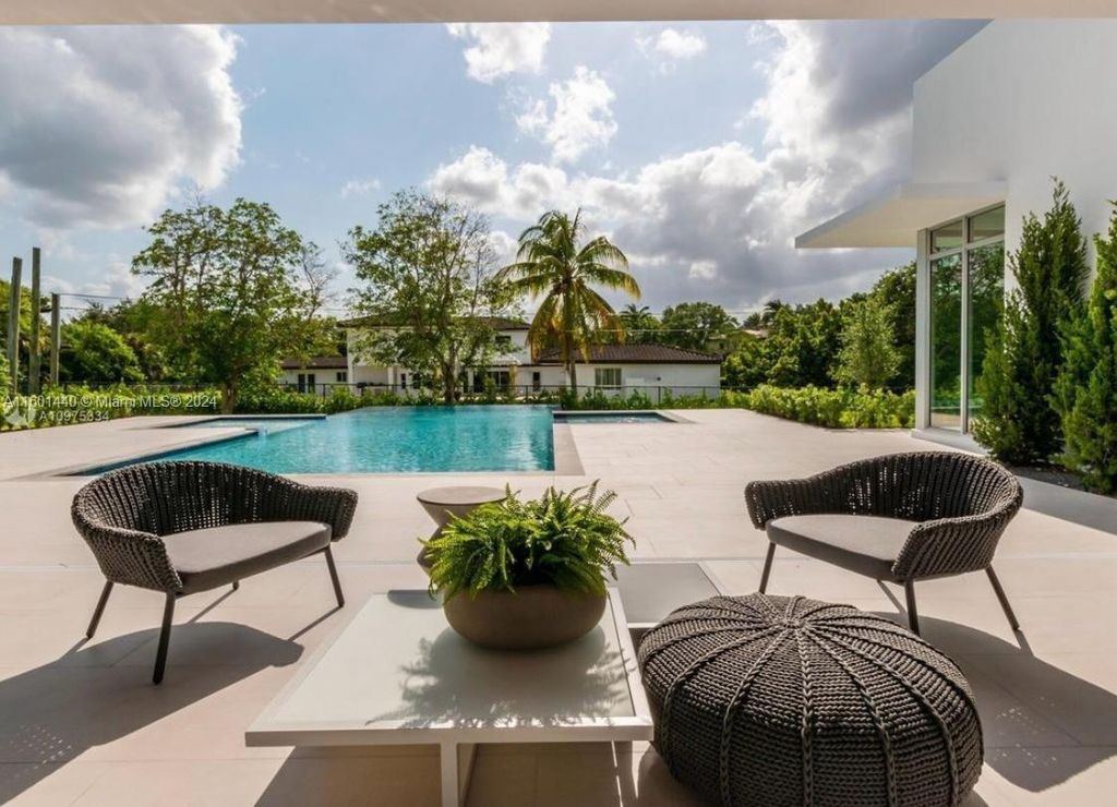 Featuring an infinity pool, a modern kitchen with top-of-the-line appliances, a stunning master suite, and close proximity to Gulliver Preparatory School, this expansive property offers the perfect blend of indoor and outdoor living.