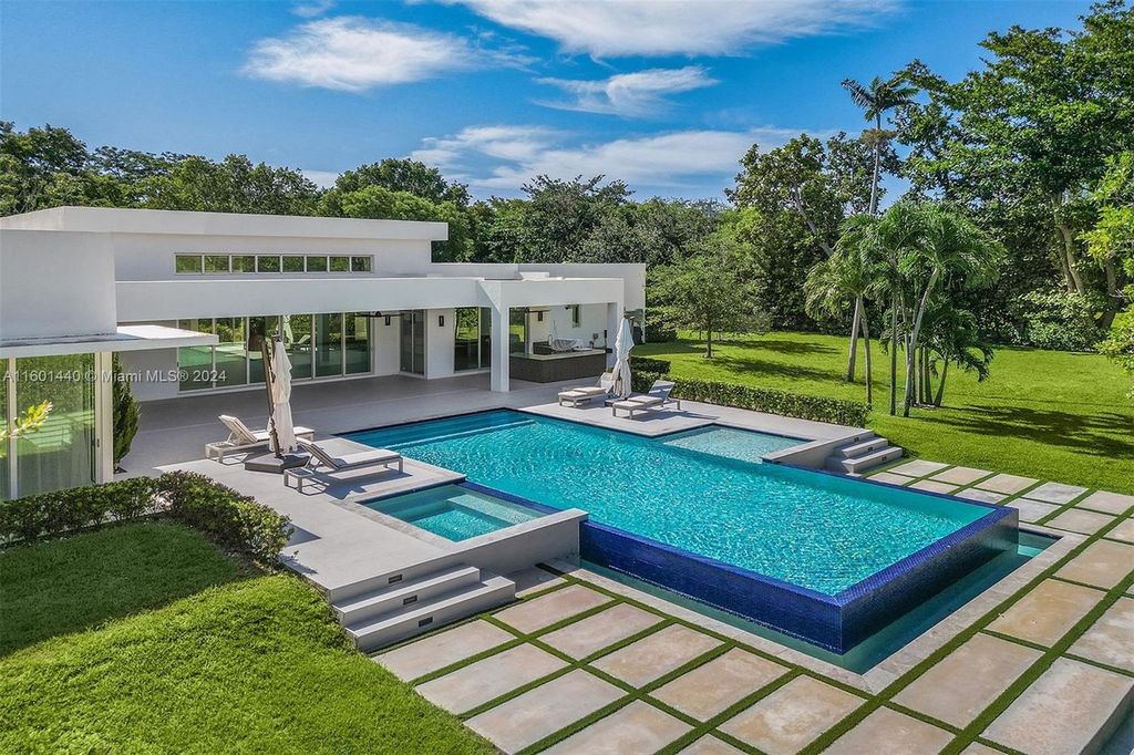 Featuring an infinity pool, a modern kitchen with top-of-the-line appliances, a stunning master suite, and close proximity to Gulliver Preparatory School, this expansive property offers the perfect blend of indoor and outdoor living.