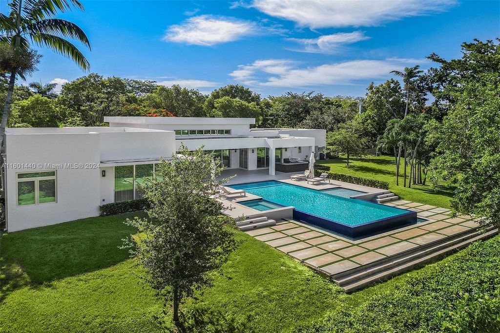 Featuring an infinity pool, a modern kitchen with top-of-the-line appliances, a stunning master suite, and close proximity to Gulliver Preparatory School, this expansive property offers the perfect blend of indoor and outdoor living.