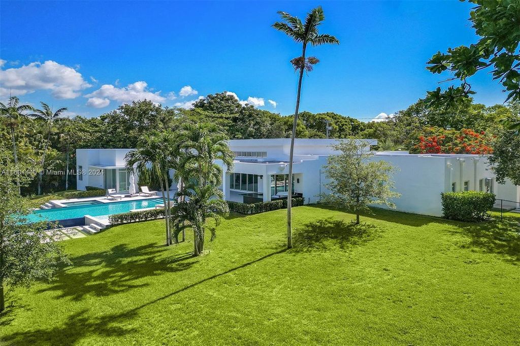 Featuring an infinity pool, a modern kitchen with top-of-the-line appliances, a stunning master suite, and close proximity to Gulliver Preparatory School, this expansive property offers the perfect blend of indoor and outdoor living.