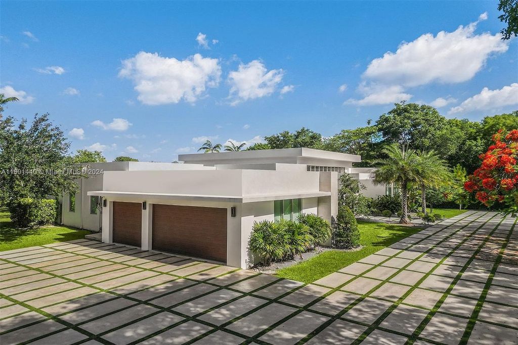 Featuring an infinity pool, a modern kitchen with top-of-the-line appliances, a stunning master suite, and close proximity to Gulliver Preparatory School, this expansive property offers the perfect blend of indoor and outdoor living.