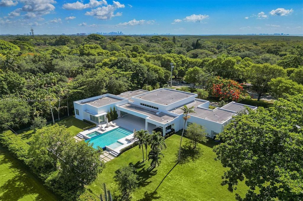 Featuring an infinity pool, a modern kitchen with top-of-the-line appliances, a stunning master suite, and close proximity to Gulliver Preparatory School, this expansive property offers the perfect blend of indoor and outdoor living.