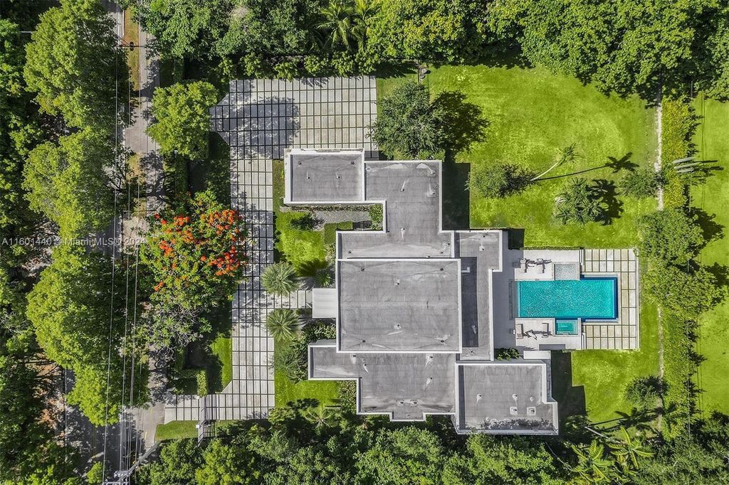 Featuring an infinity pool, a modern kitchen with top-of-the-line appliances, a stunning master suite, and close proximity to Gulliver Preparatory School, this expansive property offers the perfect blend of indoor and outdoor living.