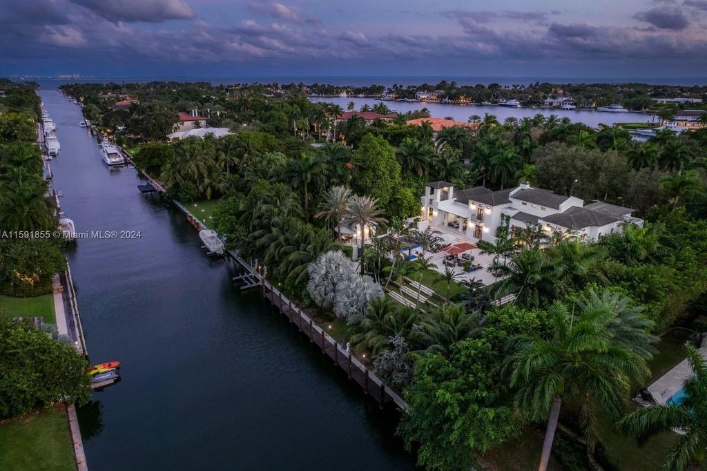 Designed by Christina Leon, this 13,147 square feet estate in Gables Estates offers unparalleled luxury. 4 beds and staff quarters, theater, gym, sauna, wine cellar, and expansive outdoor living with pool, jacuzzi, and private dock. Your waterfront paradise awaits!