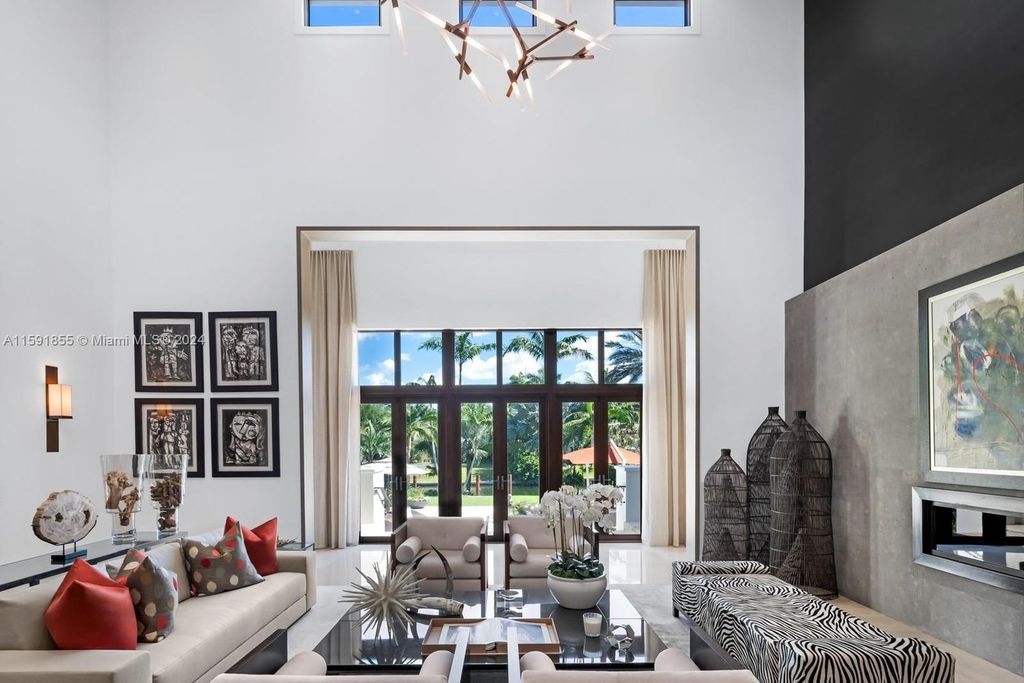 Designed by Christina Leon, this 13,147 square feet estate in Gables Estates offers unparalleled luxury. 4 beds and staff quarters, theater, gym, sauna, wine cellar, and expansive outdoor living with pool, jacuzzi, and private dock. Your waterfront paradise awaits!