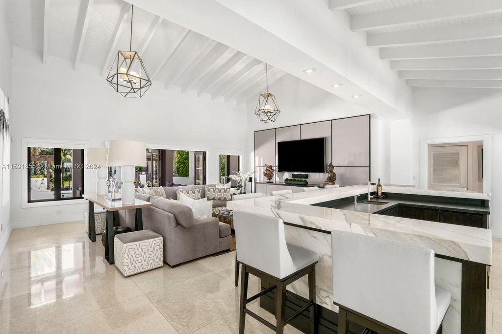 Designed by Christina Leon, this 13,147 square feet estate in Gables Estates offers unparalleled luxury. 4 beds and staff quarters, theater, gym, sauna, wine cellar, and expansive outdoor living with pool, jacuzzi, and private dock. Your waterfront paradise awaits!