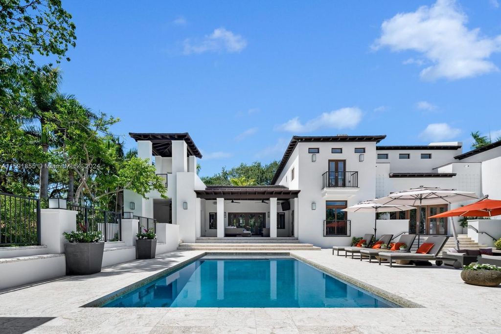 Designed by Christina Leon, this 13,147 square feet estate in Gables Estates offers unparalleled luxury. 4 beds and staff quarters, theater, gym, sauna, wine cellar, and expansive outdoor living with pool, jacuzzi, and private dock. Your waterfront paradise awaits!