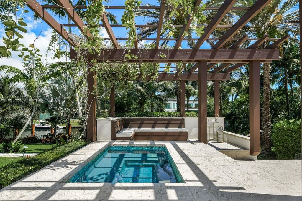 Designed by Christina Leon, this 13,147 square feet estate in Gables Estates offers unparalleled luxury. 4 beds and staff quarters, theater, gym, sauna, wine cellar, and expansive outdoor living with pool, jacuzzi, and private dock. Your waterfront paradise awaits!