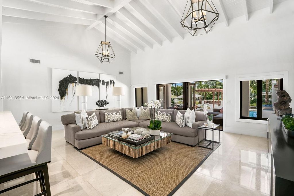 Designed by Christina Leon, this 13,147 square feet estate in Gables Estates offers unparalleled luxury. 4 beds and staff quarters, theater, gym, sauna, wine cellar, and expansive outdoor living with pool, jacuzzi, and private dock. Your waterfront paradise awaits!