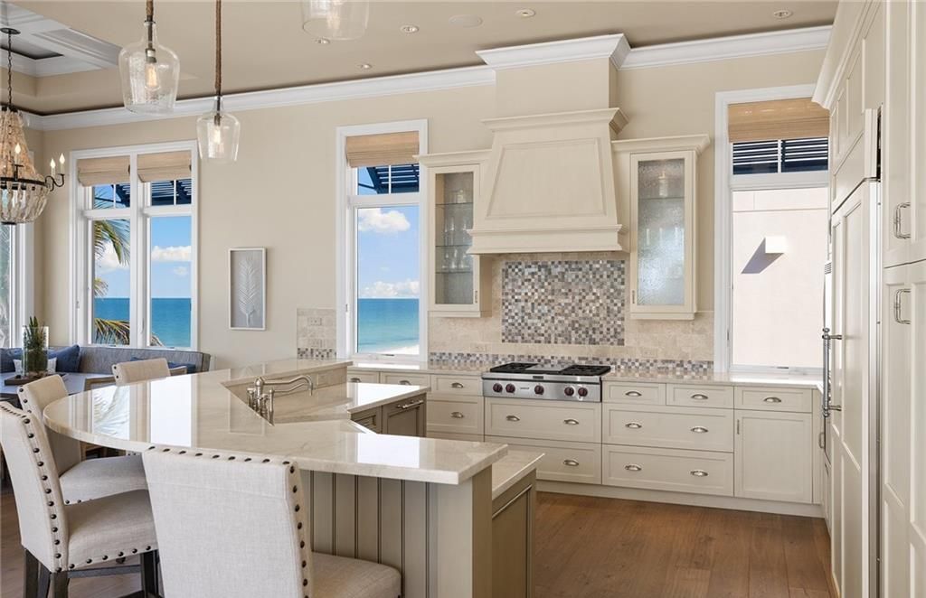 Immerse yourself in luxury living at this 7,490 sq ft beachfront estate. Custom-built with high-end finishes, this 4-bedroom home boasts a chef's kitchen, private pool, and expansive Gulf views. Perfect for entertaining, with private balconies and an open floor plan. Live the Barefoot Beach dream today!