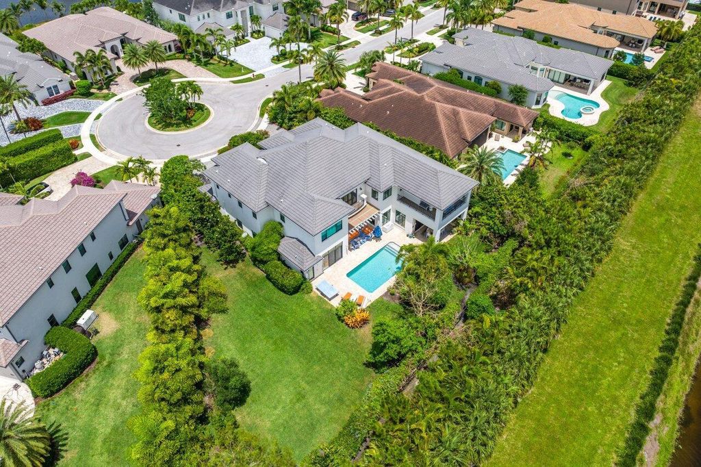 Indulge in luxury living at this sprawling 7,600 SF estate featured in Palm Beach Illustrated. Nestled in prestigious Kensington enclave, this home boasts a private backyard oasis with pool, summer kitchen, and lush landscaping. Residents enjoy world-class amenities in Seven Bridges!