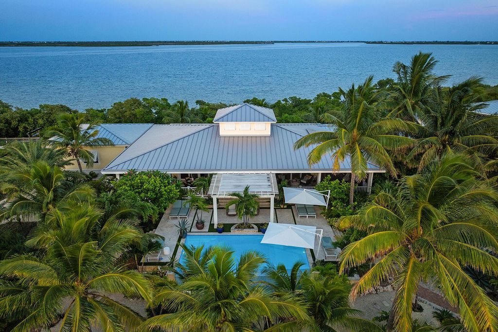 Seeking a one-of-a-kind escape? Howell Key, a turnkey 9.69-acre island paradise, awaits! This off-grid oasis boasts a 5-bedroom immaculate home, saltwater pool, guest house, helipad. Direct ocean access, proximity to Looe Key Sanctuary, and a second ROGO-exempt permit for your dream home make this the ultimate investment opportunity. Live your island dream or create an unforgettable vacation rental experience.