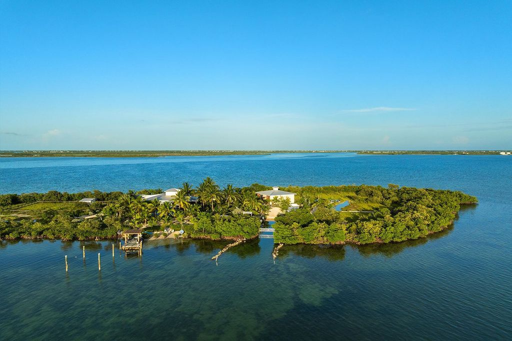 Seeking a one-of-a-kind escape? Howell Key, a turnkey 9.69-acre island paradise, awaits! This off-grid oasis boasts a 5-bedroom immaculate home, saltwater pool, guest house, helipad. Direct ocean access, proximity to Looe Key Sanctuary, and a second ROGO-exempt permit for your dream home make this the ultimate investment opportunity. Live your island dream or create an unforgettable vacation rental experience.